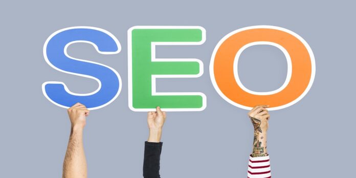 Hands holding up colorful letters forming the abbreviation SEO ecommerce SEO expert